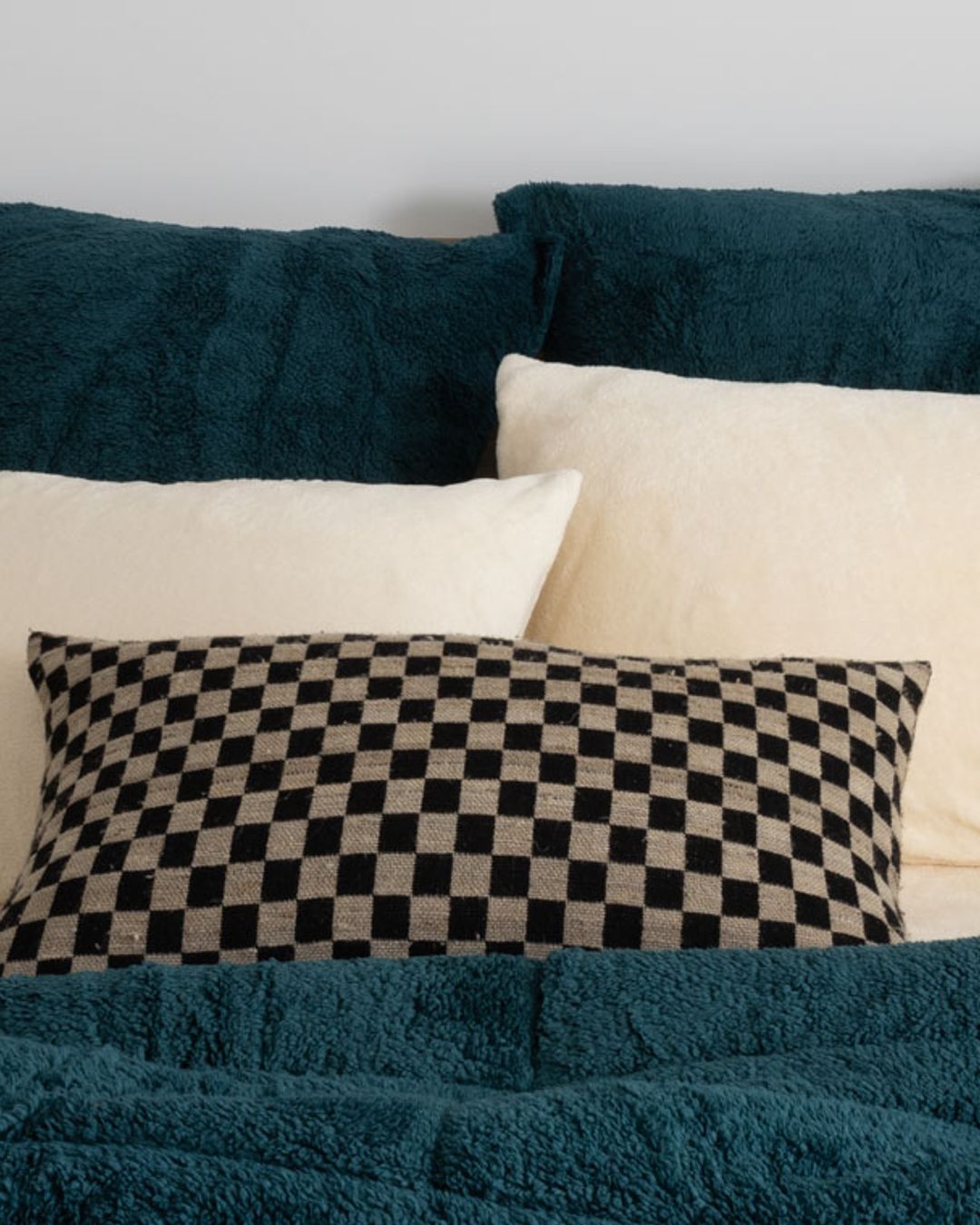 Morgan and Reid Deep Teal Snuggle Fleece European Pillowcase Pair on bed with coordinating bedding