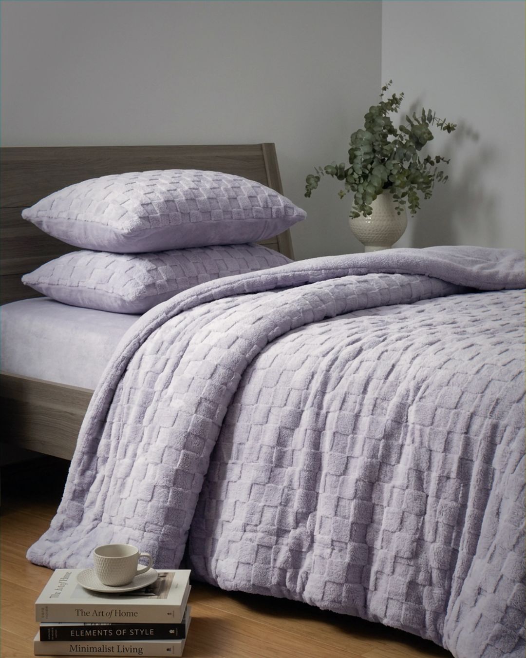 Lavender checkered snuggle fleece comforter set styled on bed with matching pillows and eucalyptus decor