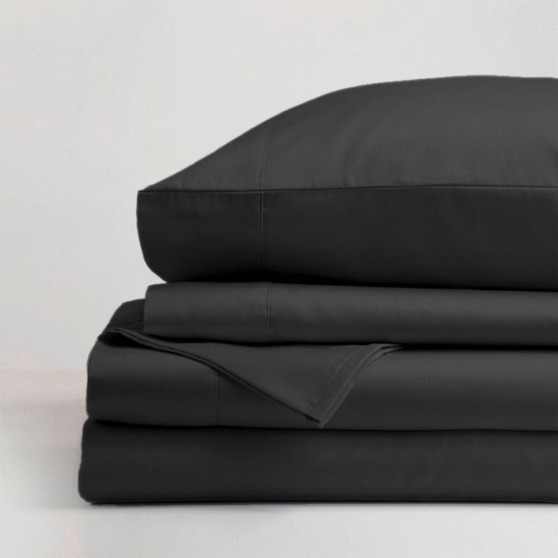 The Morgan and Reid Hotel 1500 Thread Count Cotton Rich Sheet Set, with pillowcases and one pillow on top, is neatly stacked and displayed against a plain light gray background.