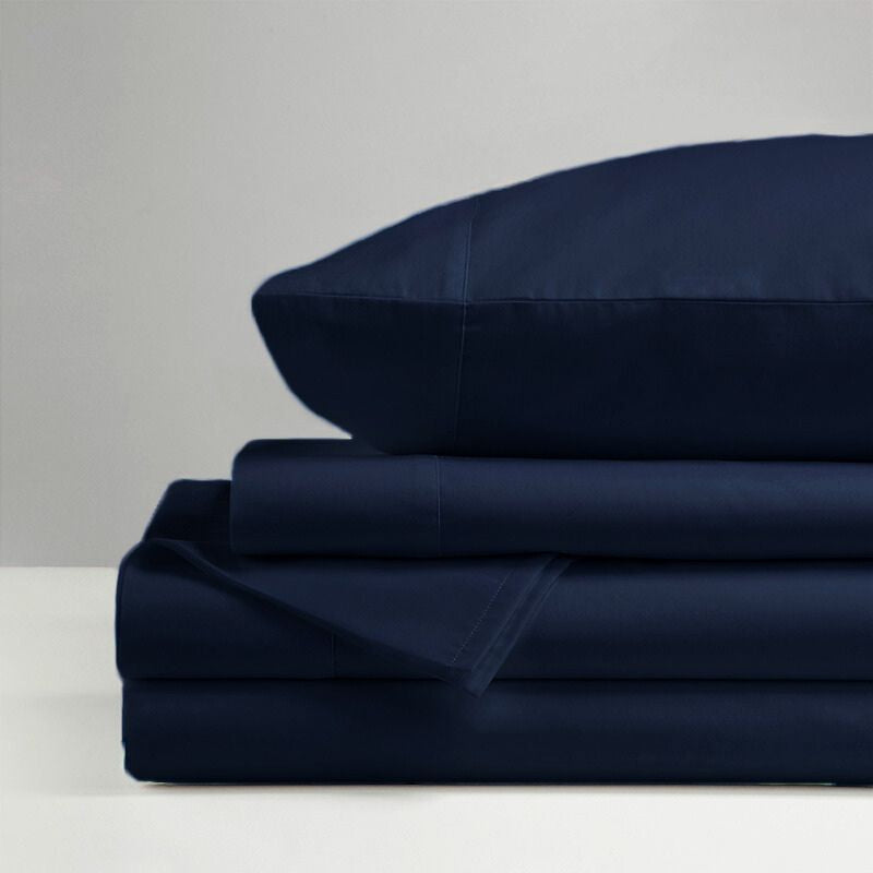 The Morgan and Reid Hotel 1500 Thread Count Cotton Rich Sheet Set, with pillowcases and one pillow on top, is neatly stacked and displayed against a plain light gray background.