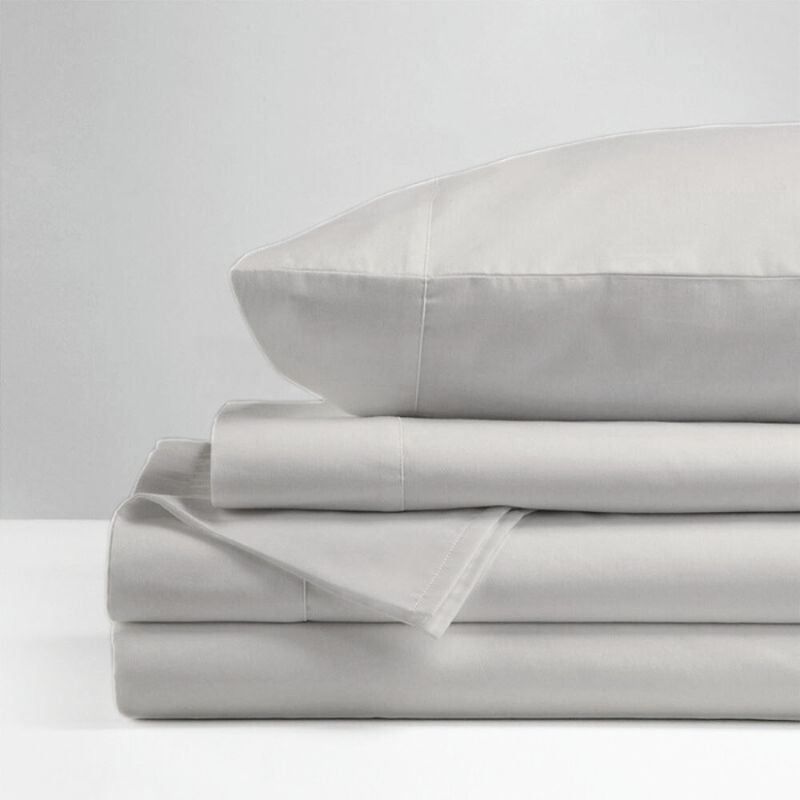 The Morgan and Reid Hotel 1500 Thread Count Cotton Rich Sheet Set, with pillowcases and one pillow on top, is neatly stacked and displayed against a plain light gray background.