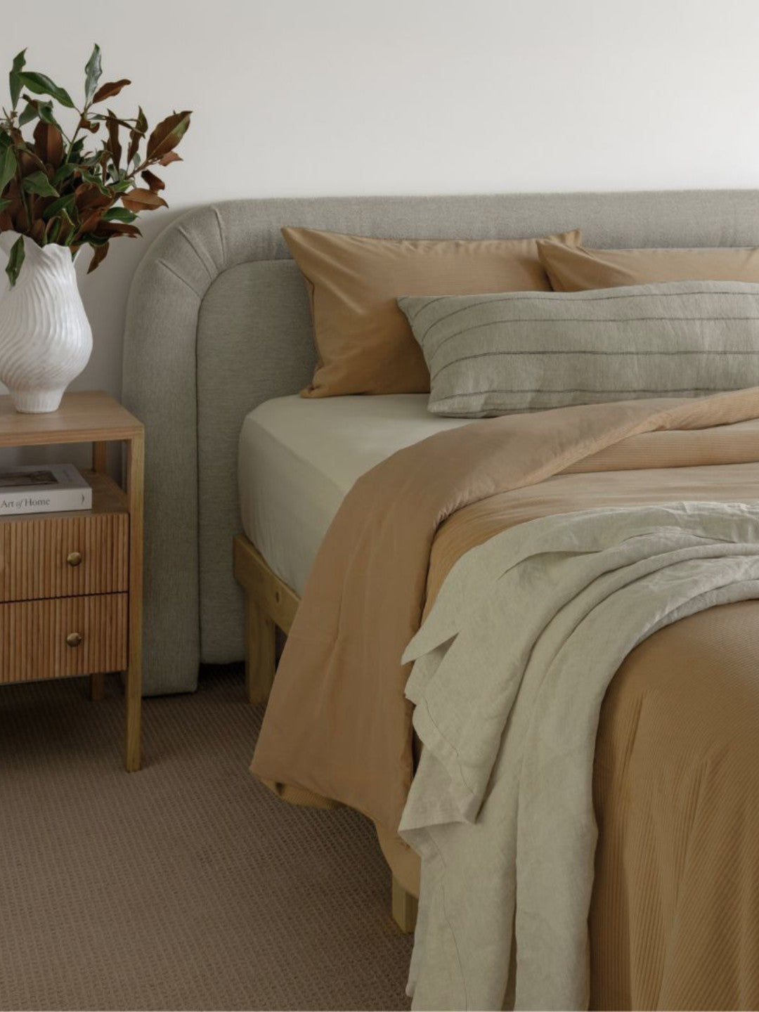 Cozy bedroom with a bed, nightstand, and decorative elements.