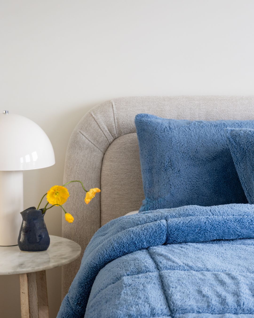 Morgan and Reid All Seasons Snuggle Fleece Smokey Blue Comforter Set on a bed with matching pillowcases