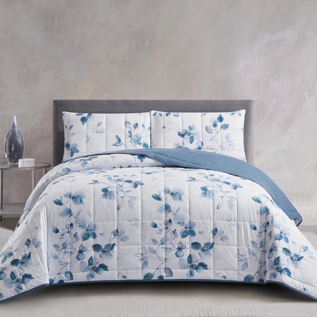 Morgan and Reid Blue Eucalyptus Cloudy Coverlet Set draped over a neatly made bed