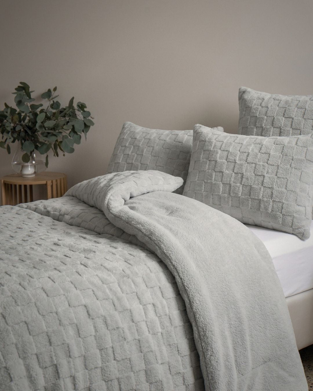 Morgan and Reid Checkered Silver Snuggle Fleece European Pillowcase Pair on bed with coordinating bedding
