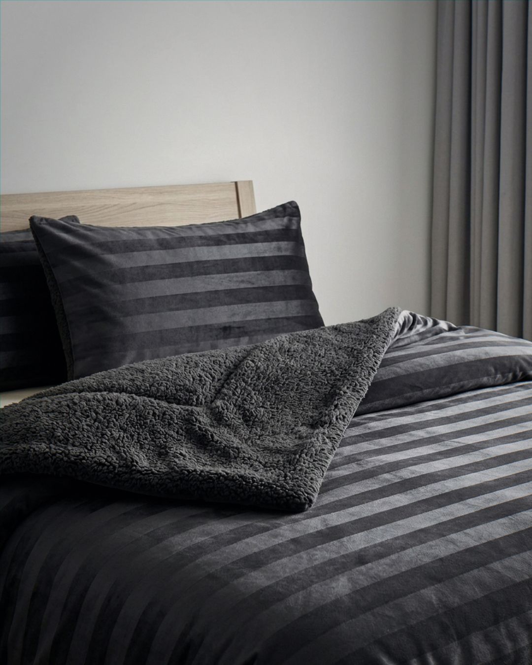 Morgan and Reid Black Velvet Stripe Crushed Snuggle Fleece Pillowcase Pair on bed with coordinating bedding