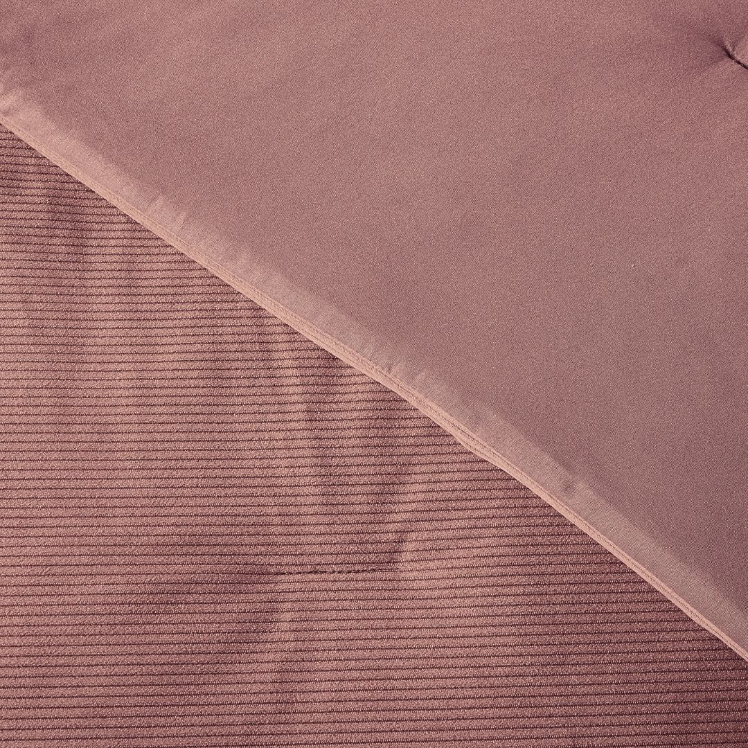 Close-up of a pink textured fabric with a diagonal pattern