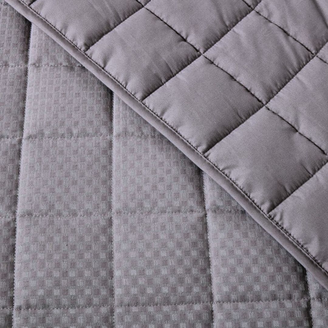 Close-up of a quilted gray fabric with diamond pattern