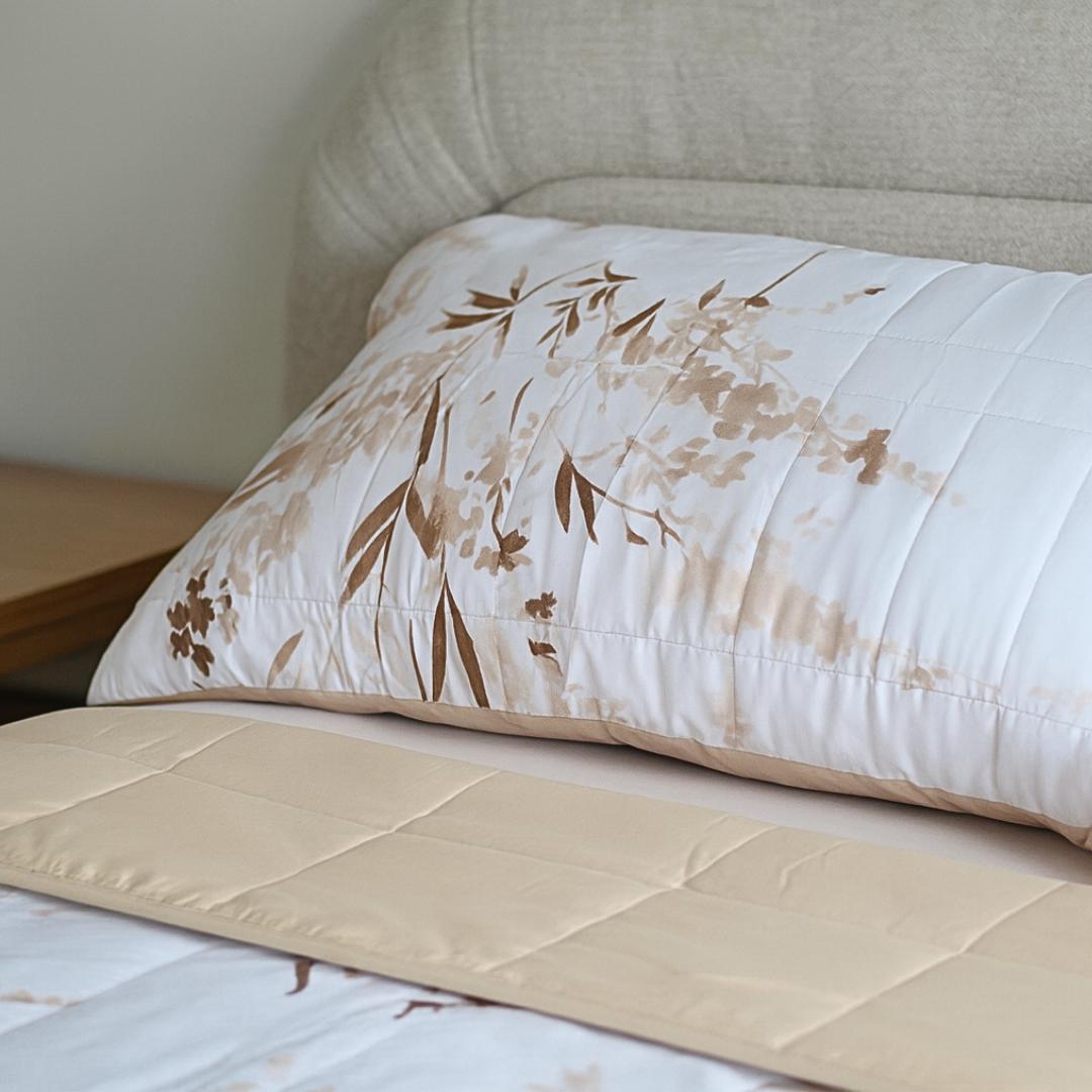 Close-up of golden floral quilted design and stitching.