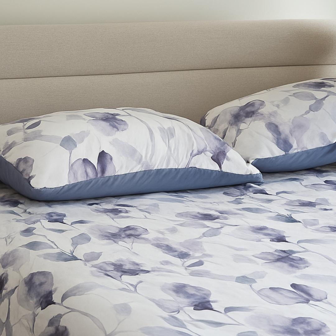 Morgan and Reid Midnight Orchid Cloudy Coverlet Set - Close-up of watercolour floral quilted fabric in grey and indigo.