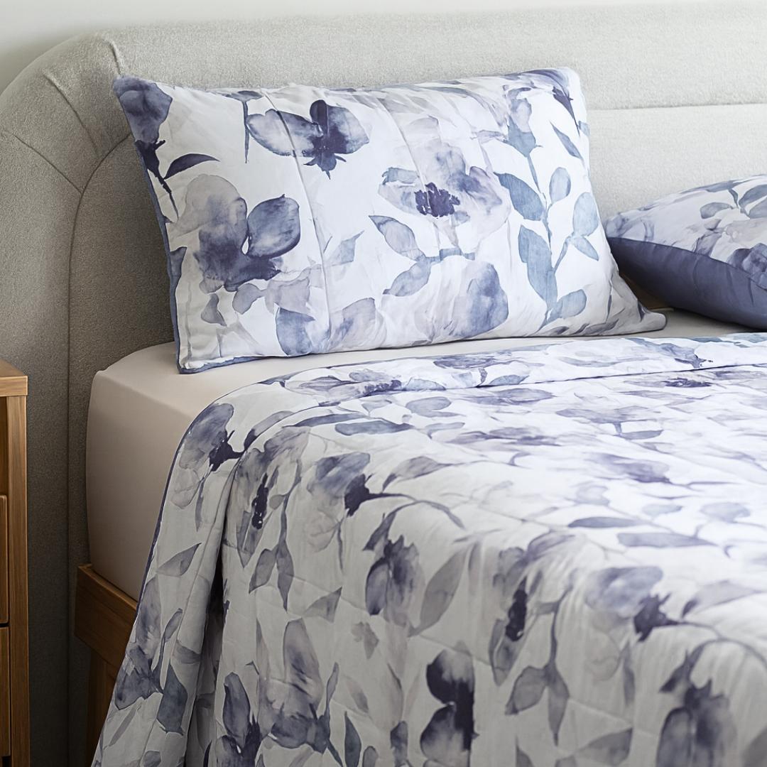 Morgan and Reid Midnight Orchid Cloudy Coverlet Set - Close-up of watercolour floral quilted fabric in grey and indigo.