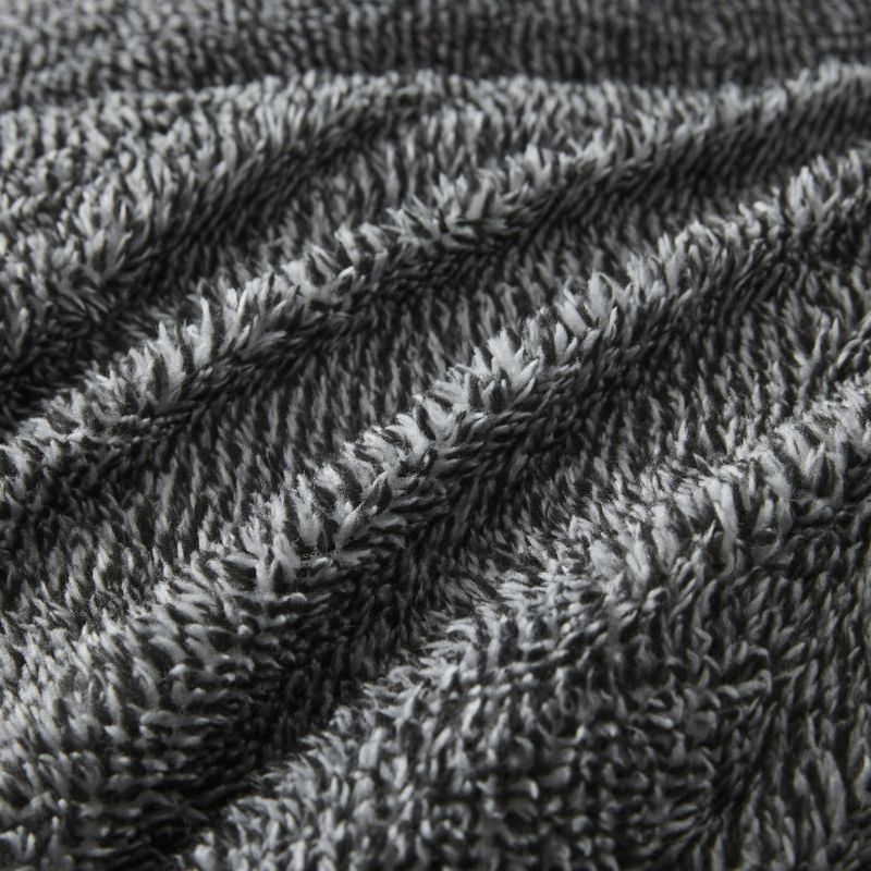 A rectangular, dark gray textured pillow is shown against a white background, ideal for cosy bedding. Pair it with the Morgan and Reid Black White Snuggle Fleece Pillowcase Pair for style and comfort.