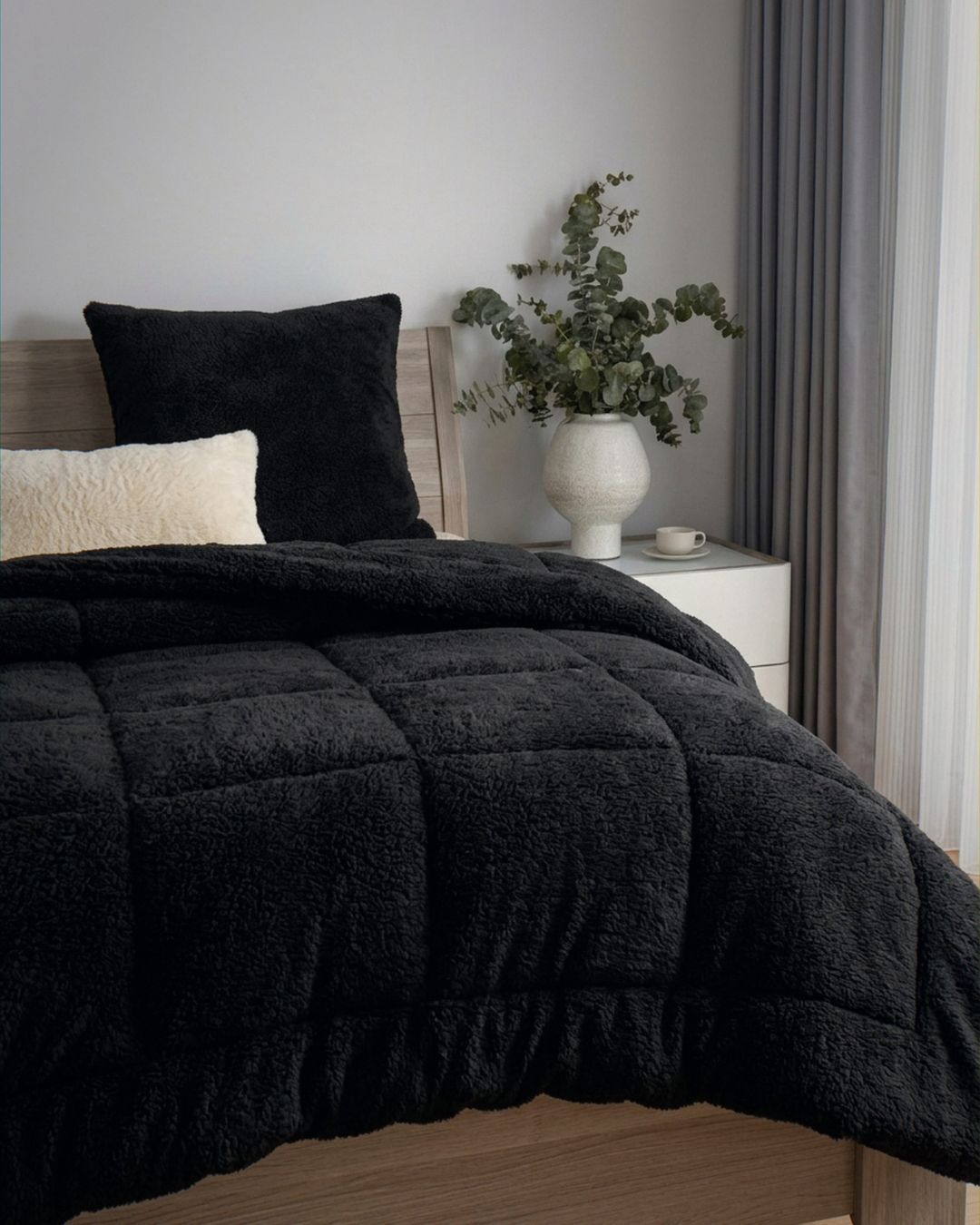 Overhead view of the Morgan and Reid Black Snuggle Fleece Comforter Set on a made bed