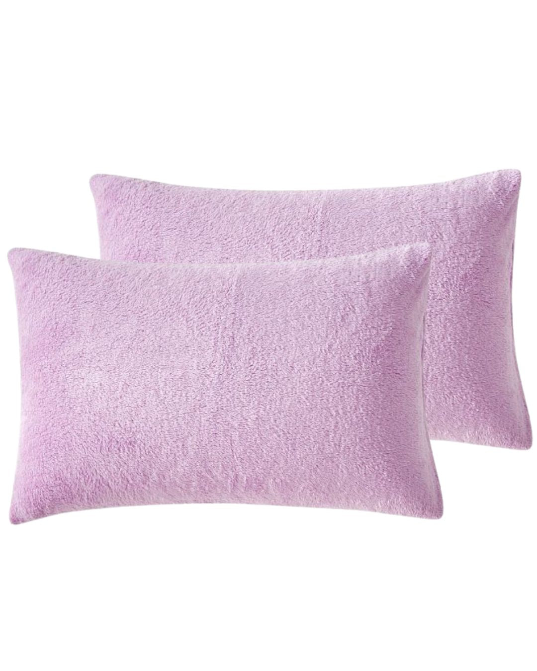 Morgan and Reid Calm Lavender Snuggle Fleece Pillowcase Pair on a styled bed with matching comforter