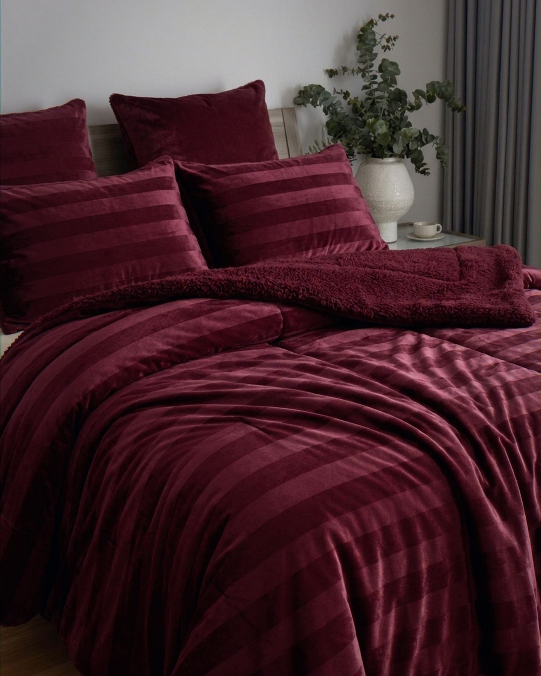 Detail shot of the Morgan and Reid Cherry Red Velvet Stripe Crushed Snuggle Fleece Pillowcase Pair on pillows