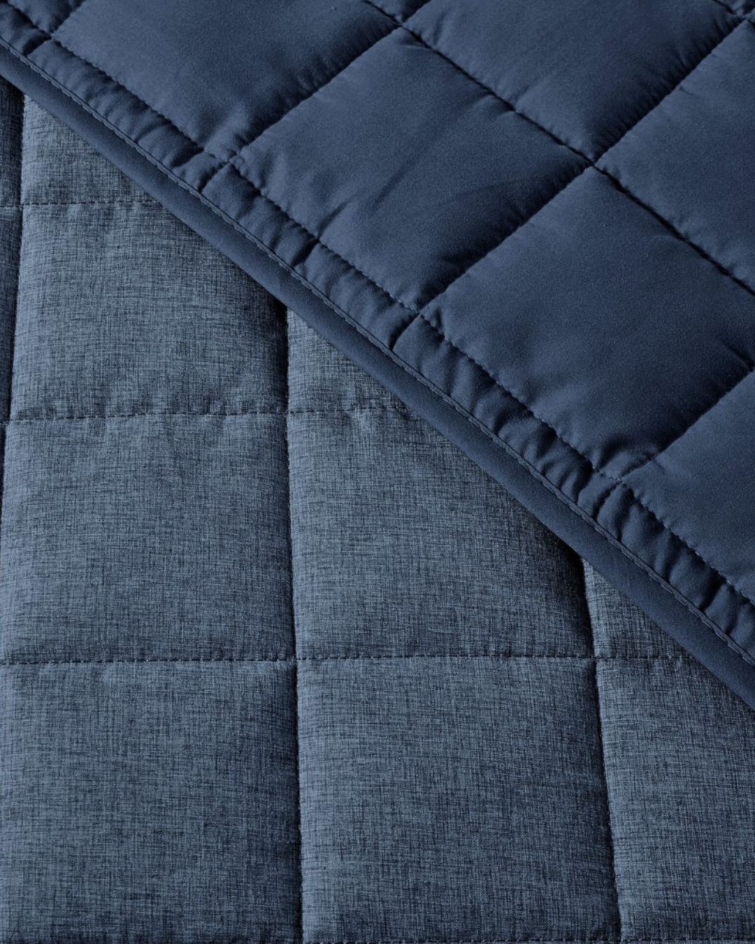 Close-up of a blue quilted fabric with a textured surface