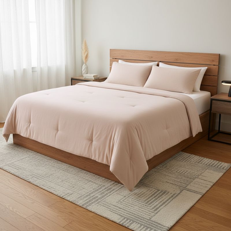 Beige comforter on a wooden bed in a bedroom setting