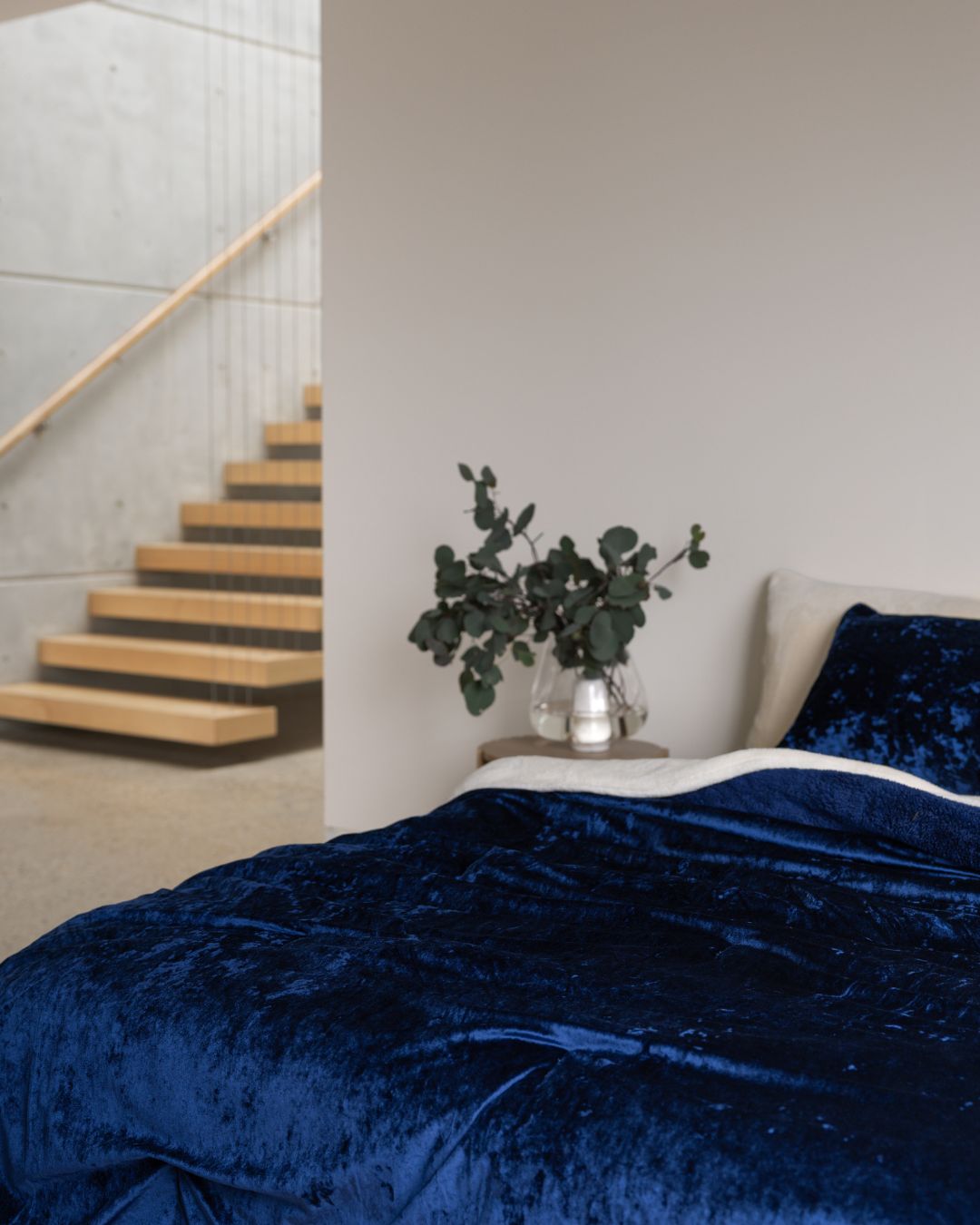 Morgan and Reid Navy Velvet Crushed Snuggle Fleece Comforter Set on a bed with matching pillowcases