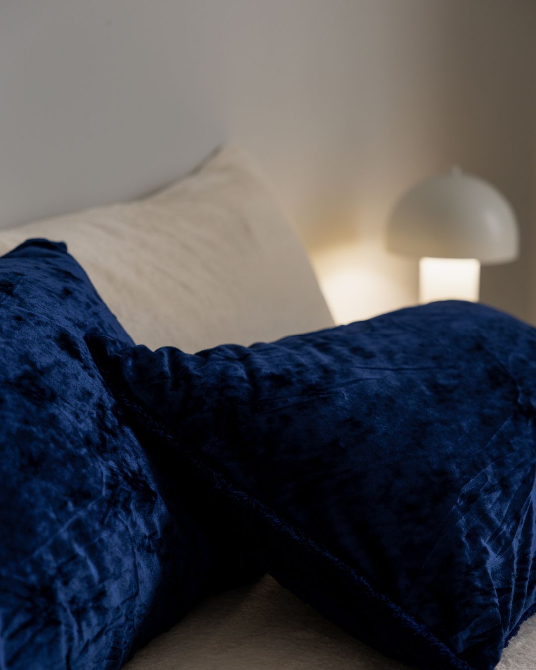 Morgan and Reid Navy Velvet Crushed Snuggle Fleece Pillowcase Pair on bed with coordinating bedding