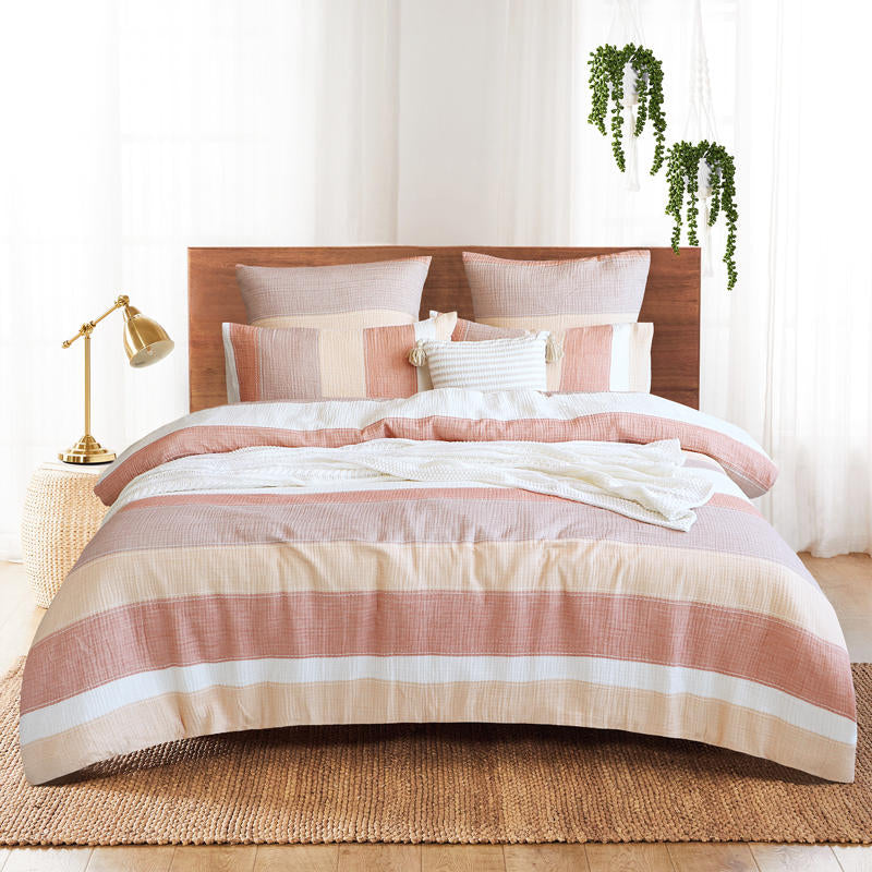 Styled bed featuring Renee Taylor Bayley European Pillowcases in soft earthy tones.