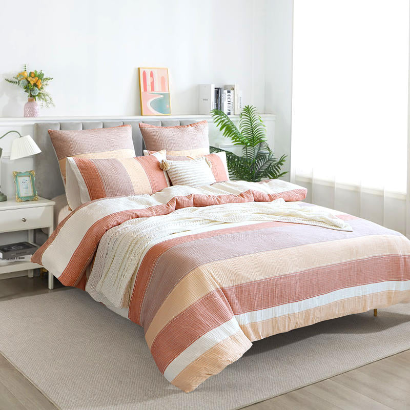 Styled bed featuring Renee Taylor Bayley European Pillowcases in soft earthy tones.