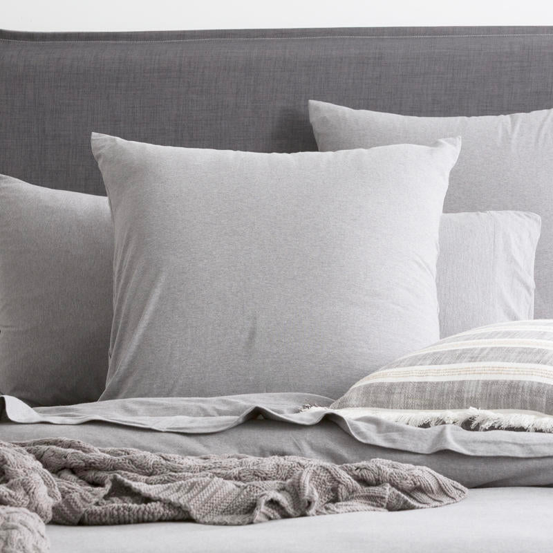 Styled bed featuring Renee Taylor Charcoal European Pillowcase with matching jersey bedding.