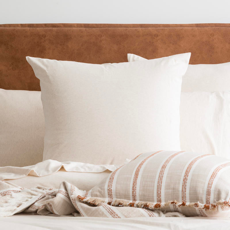 Styled bed featuring Renee Taylor Oatmeal European Pillowcase with matching jersey bedding.