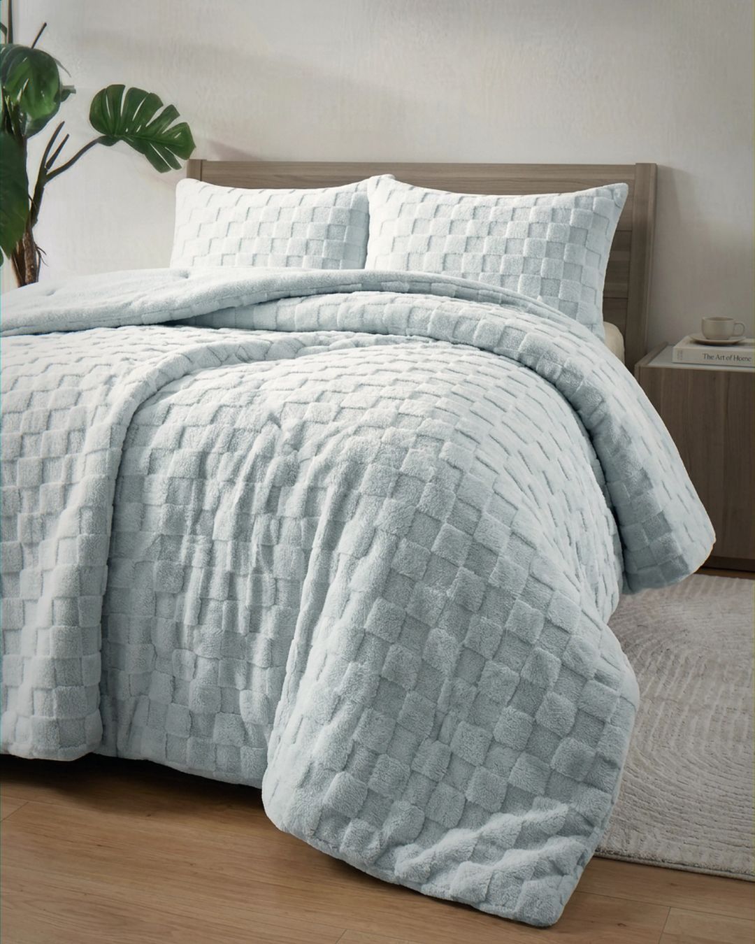 Soft blue checkered snuggle fleece comforter set styled on bed with matching pillow shams in modern bedroom