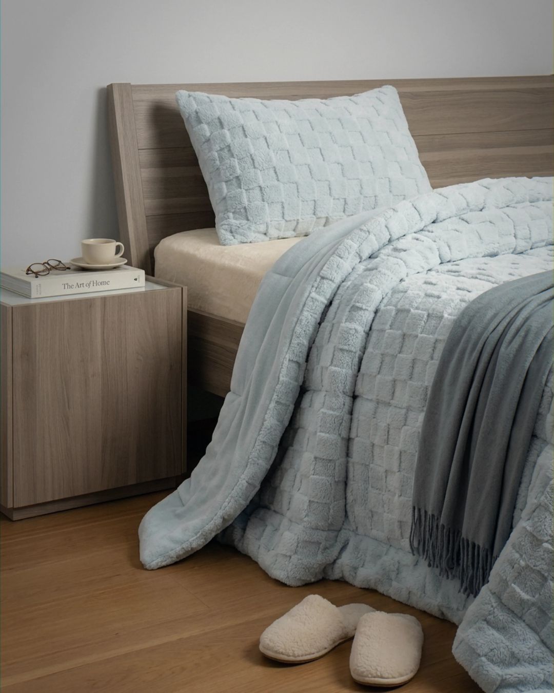 Soft Blue Checkered Snuggle Fleece Comforter Set styled on bed with matching pillow sham and cozy bedroom setting