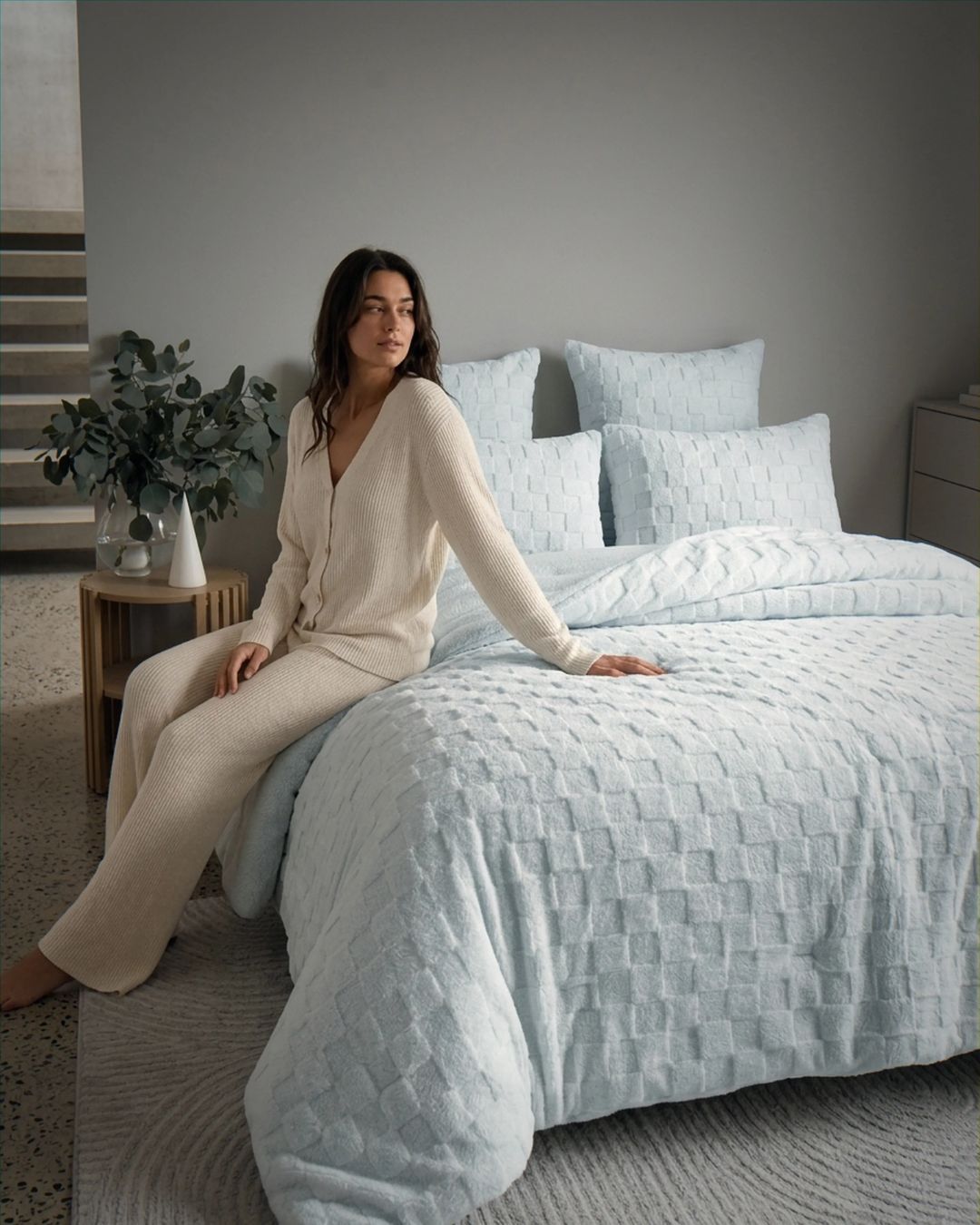 Lifestyle shot of soft blue checkered fleece comforter set styled on bed with matching pillow shams