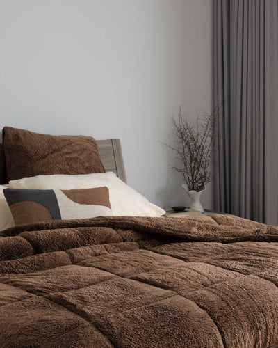 Morgan and Reid Cocoa Snuggle Fleece European Pillowcase Pair on bed with coordinating bedding