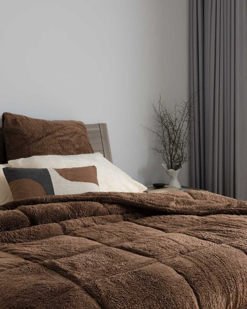 Morgan and Reid Cocoa Snuggle Fleece European Pillowcase Pair on bed with coordinating bedding
