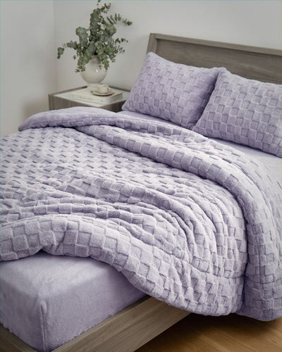 Lavender checkered snuggle fleece comforter set styled on bed with matching pillows and fitted sheet