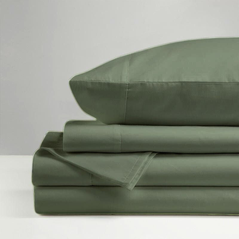 The Morgan and Reid Hotel 1500 Thread Count Cotton Rich Sheet Set, with pillowcases and one pillow on top, is neatly stacked and displayed against a plain light gray background.