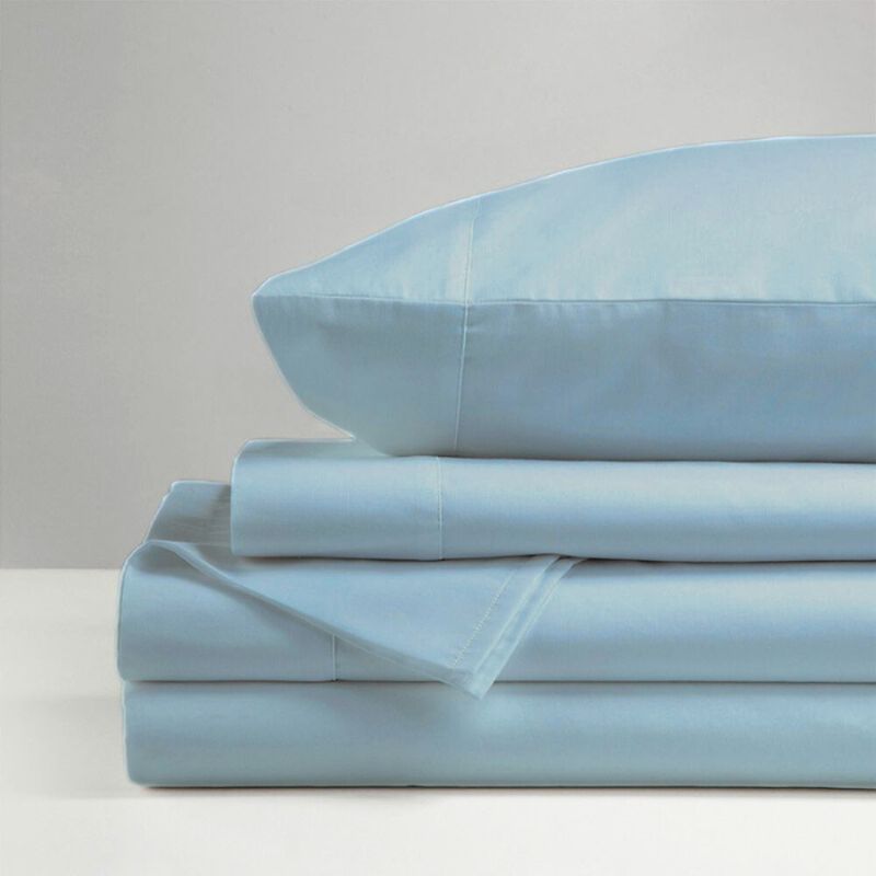 The Morgan and Reid Hotel 1500 Thread Count Cotton Rich Sheet Set, with pillowcases and one pillow on top, is neatly stacked and displayed against a plain light gray background.