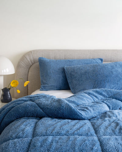 Morgan and Reid All Seasons Snuggle Fleece Smokey Blue Comforter Set in a cosy bedroom lifestyle setting