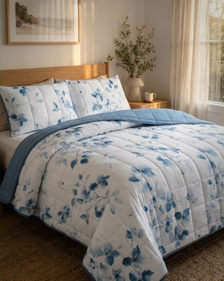 Bed with blue and white floral comforter in a bedroom setting