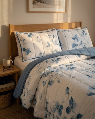 Floral bedding set on a bed with a wooden headboard and side table.