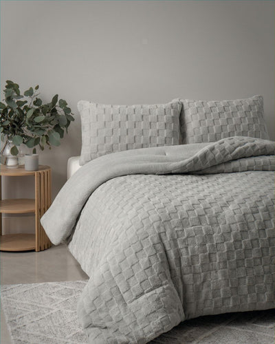 Detail shot of the Morgan and Reid Checkered Silver Snuggle Fleece Pillowcase Pair on pillows