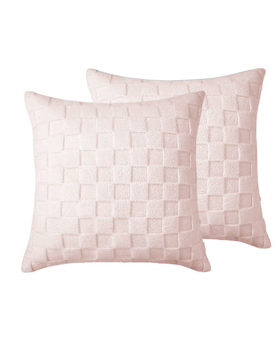 Two pink woven patterned pillows on a white background