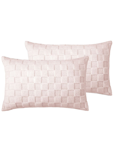 Two pink woven pillows on a white background