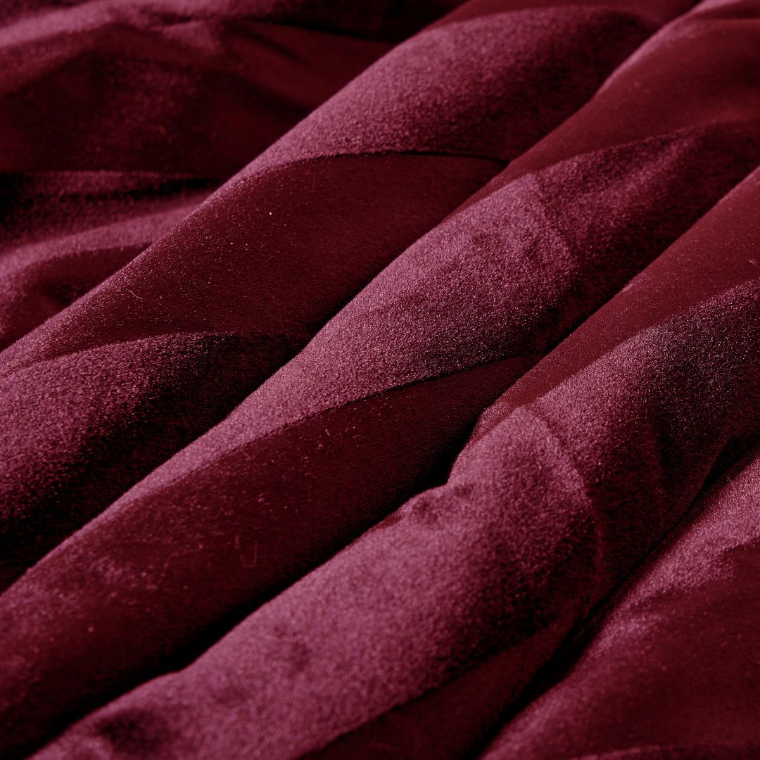 The Morgan and Reid Cherry Red Velvet Stripe Snuggle Fleece European Pillowcase Pair features alternating shiny and matte burgundy stripes, perfect for layering with square throw pillows or adding style to your bed.