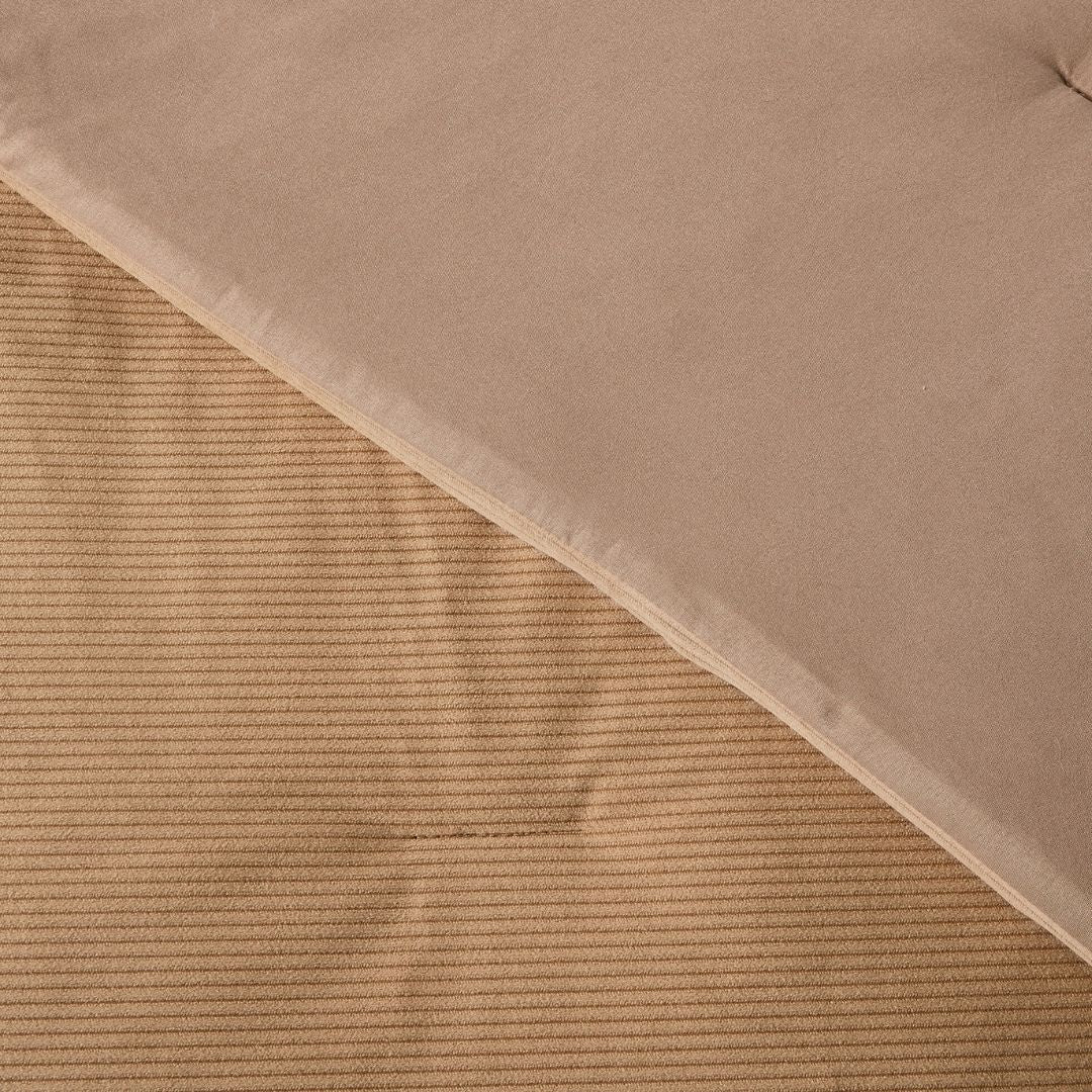 Close-up of a textured brown fabric with a ribbed pattern