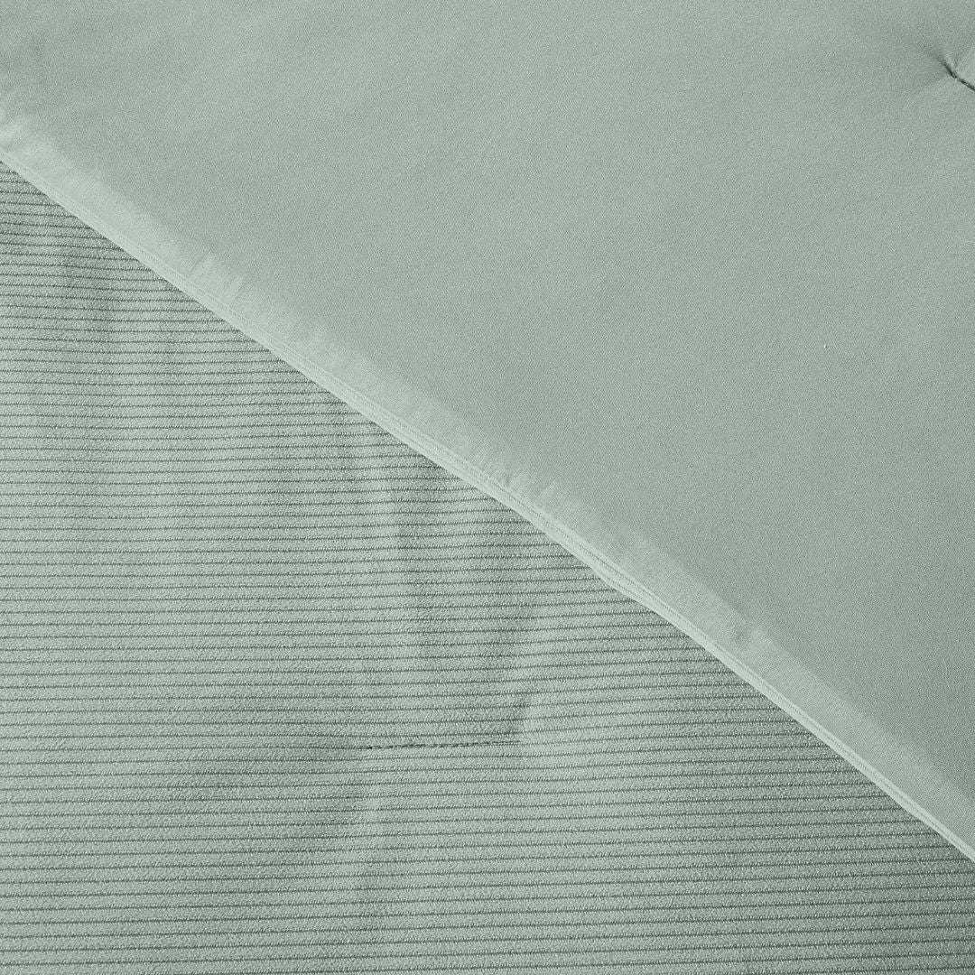 Textured fabric with a diagonal pattern on a light gray background