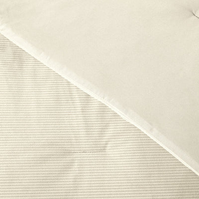 Close-up of a textured beige fabric with a subtle pattern