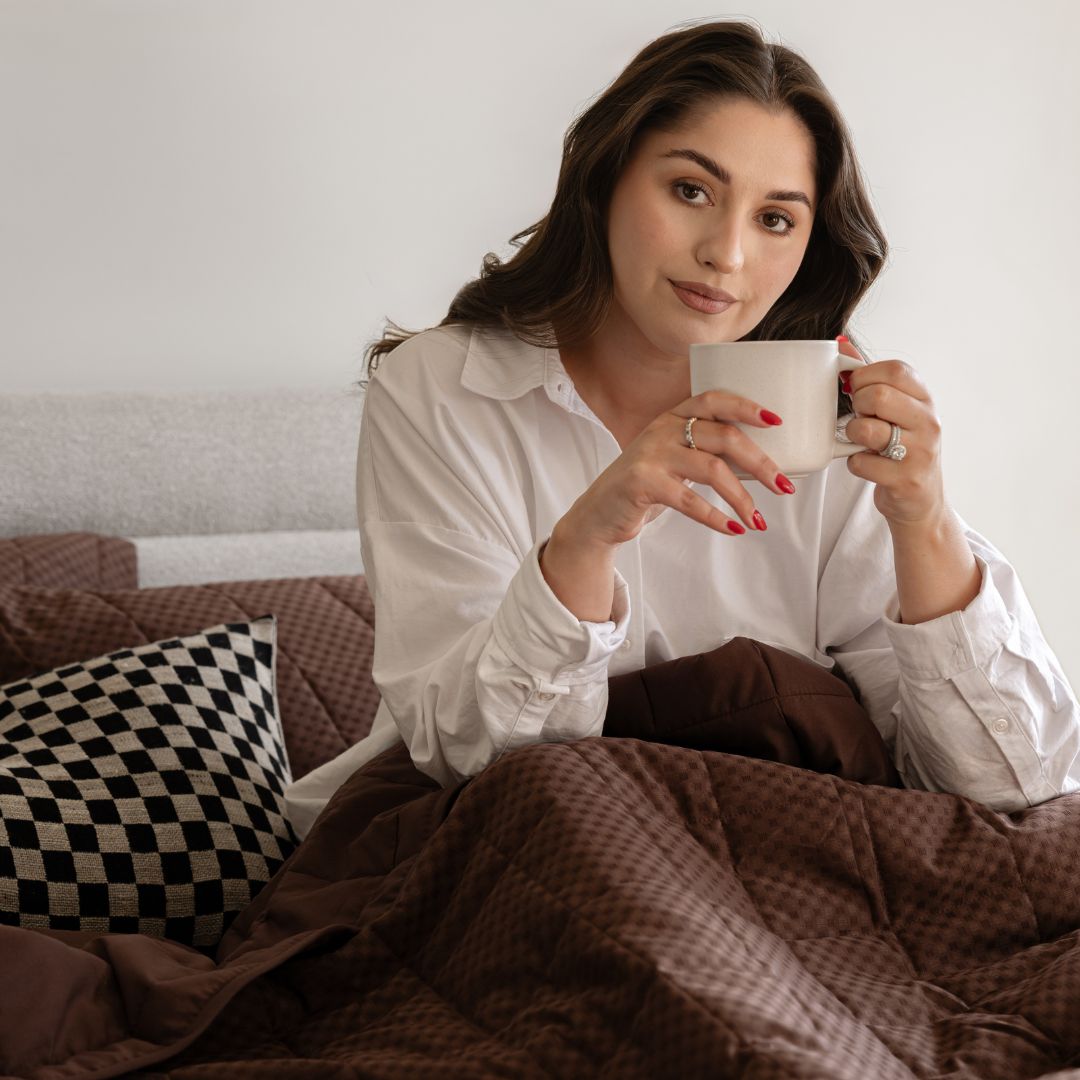 Woman holding a mug in a cozy indoor setting