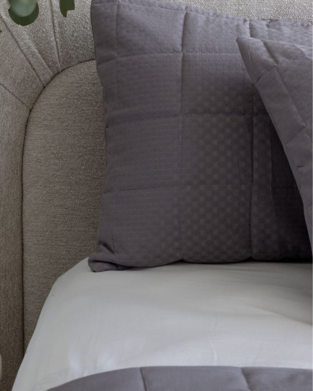 Gray textured pillow on a gray sofa