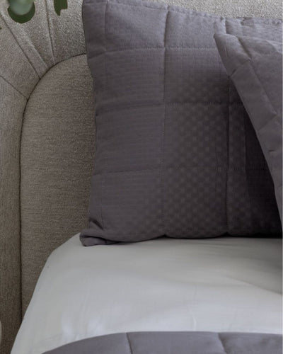 Gray textured pillow on a gray sofa