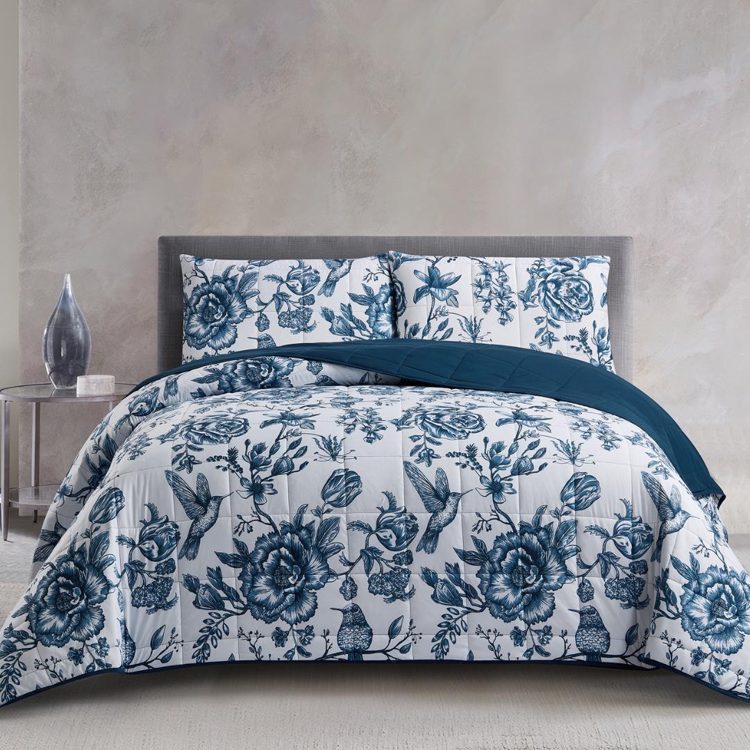 Lightweight quilted coverlet with pillowcases in classic blue rose design.