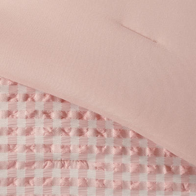 Pink checkered fabric on a pink background